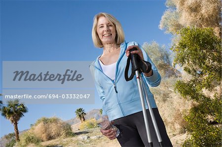 Mature woman holds walking poles
