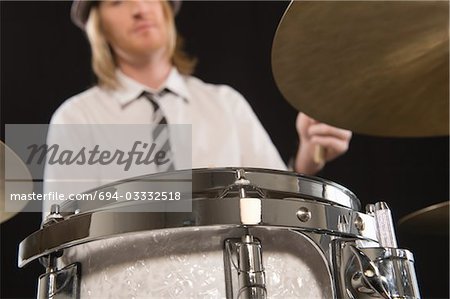 Young man plays the drums