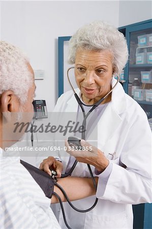 Senior medical practitioner takes blood pressure