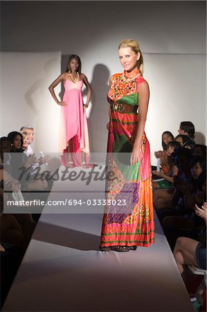 Woman in multicoloured dress on fashion catwalk