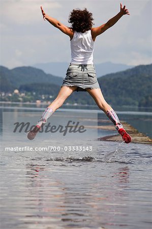Femme sautant en faible profondeur eau, Fuschlsee, Salzbourg, Autriche