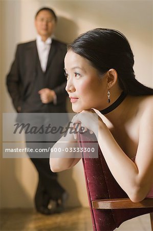 Woman Daydreaming with Man Standing in Background