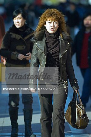 China,Beijing. A Chinese girl walking on Wanfujing Shopping street.