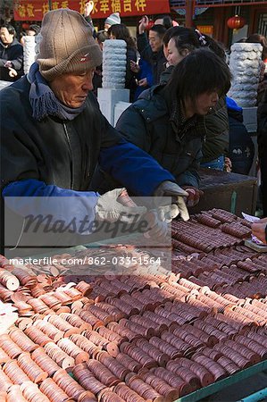 China,Beijing. Chinese New Year Spring Festival - piles of money used to throw at a bell for good luck at Baiyun Guan White Cloud Taoist Temple.