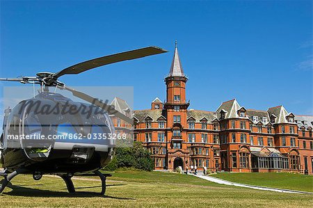 A helicopter waits to pick up guests from the Slieve Donard Hotel,at the small coastal town of Newcastle