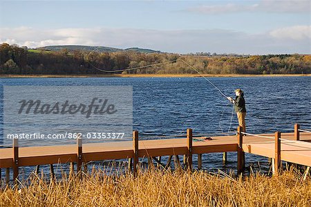 UK,Northern Ireland,Fermanagh. A fisherman fly fishing on Lough Erne .