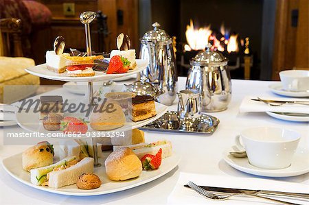 UK,Northern Ireland,Fermanagh,Enniskillen. Afternoon tea by the fire in the Garden Room at Lough Erne Golf Resort.