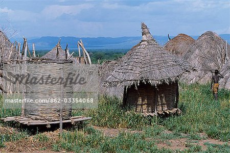 The grass huts and granary stores of a Nyangatom settlement. The Nyangatom or Bume are a Nilotic tribe of semi-nomadic pastoralists who live along the banks of the Omo River in south-western Ethiopia.