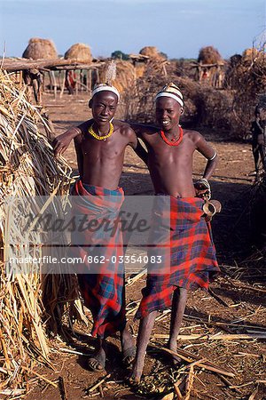 Two young Dassanech boys sport elaborate clay hairdos at their settlement alongside the Omo River. Much the largest of the tribes in the Omo Valley numbering around 50,000,the Dassanech (also known as the Galeb,Changila or Merille) are Nilotic pastoralists and agriculturalists.