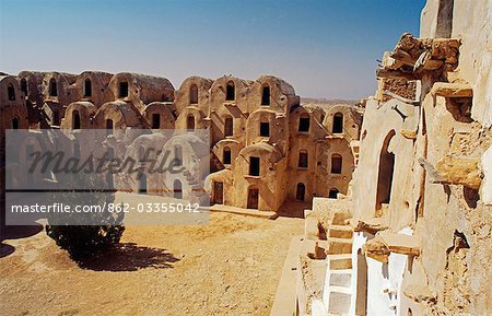 Tunisie, Jebel Abiadh. Ce ksar restauré ou grenier fortifié, est parmi les plus beaux exemples de la Tunisie de ce type d'architecture. Des centaines de ghorfas, ou des cellules de stockage, traditionnellement confrontés aux portes en bois palm entourent la Cour d'honneur.