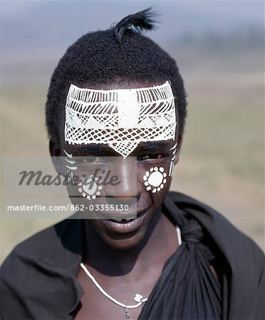 Black clothing and the intricate white patterns on the face of this Maasai youth of the Kisongo section signify his recent circumcision.