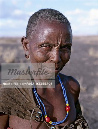 An old Datoga woman. Her traditional attire includes a beautifully tanned and decorated leather dress . The Datoga (known to their Maasai neighbours as the Mang'ati and to the Iraqw as Babaraig) live in northern Tanzania and are primarily pastoralists.