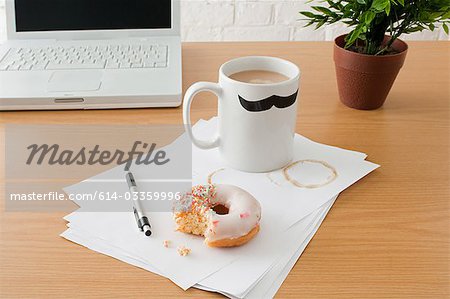 Coffee and doughnut on desk