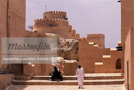 An Omani man insideNakhl Fort which stands in the foothills of the Western Hajar Mountains. The early foundations are thought to pre-date Islam. The mainly 17th century fortress visible today stands over 30 metres high and covers 3,400 square metres.