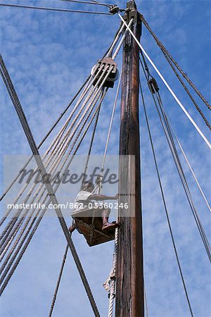 One of the crew members of S/Y Sanjeeda is pulled up the rigging in a bosun's chair. Sanjeeda is a traditional kotiya dhow of the type that traded throughout the Indian Ocean.