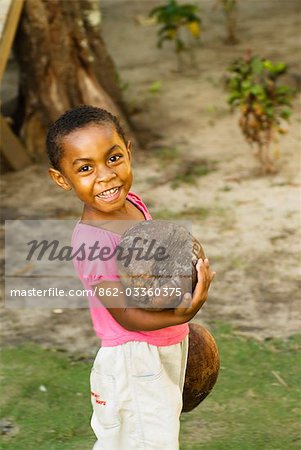 South Pacific,Fiji,Kadavu. Fijian girl - smiling and holding a coconut.