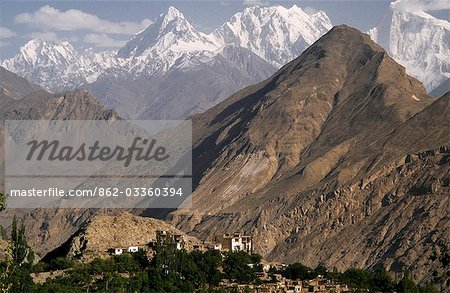 The jagged peaks and bare hills of the Karakorum Range dominate the skyline of Karimabad. The Baltit Fort towers over the village.