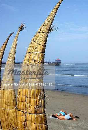 Caballitos de totora (reed boats) are stacked along the beach to dry at Huanchaco in northern Peru. The boats have been used by fishermen on Peru's northern coast for over two thousand years.