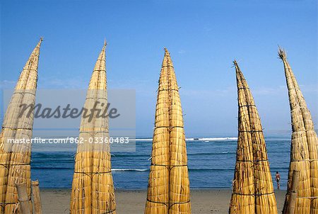 Caballitos de totora (reed boats) are stacked along the beach to dry at Huanchaco in northern Peru. The boats have been used by fishermen on Peru's northern coast for over two thousand years.