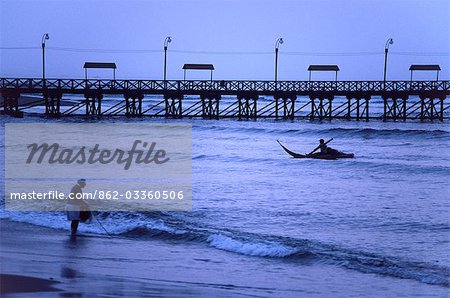 A Huanchaco fisherman returns to shore paddling a traditional totora (reed) boat,known as a caballito de totora (little horse of reeds).