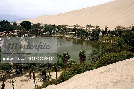 The oasis village of Huacachina,near Ica is southern Peru. The lagoon,backed by giant sand dunes,is a popular tourist destination and is featured on the S/50 banknote.