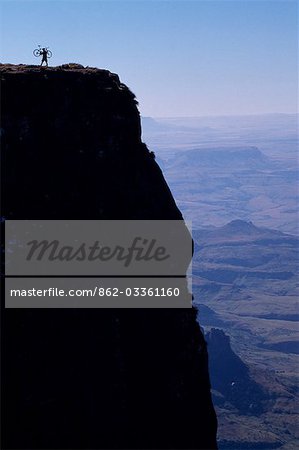 Mountain biker on the rim of The Amphitheatre,Drakensberg