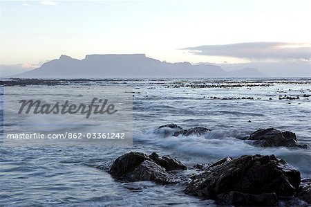 South Africa,Western Cape,Cape Town. Looking across to Melkbosstrand and Table Mountain at sunset.