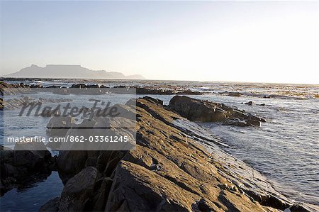 South Africa,Western Cape,Cape Town. Looking across to Melkbosstrand and Table Mountain at sunset.