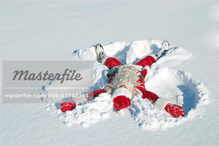 Santa making a snow angel in fresh snow