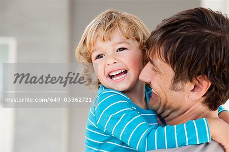 son and father hugging