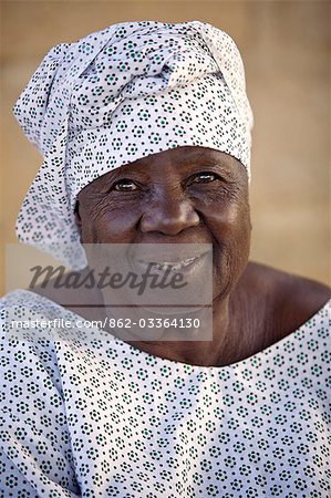 Mali,Segou. An old woman at Segou wearing a dress and matching headscarf.