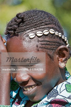 Mali,Tupe,Niger Inland Delta. A Songhay girl with cowries attached to her attractively braided hair at Tupe,a small village on the banks of the Niger River between Mopti and Timbuktu.