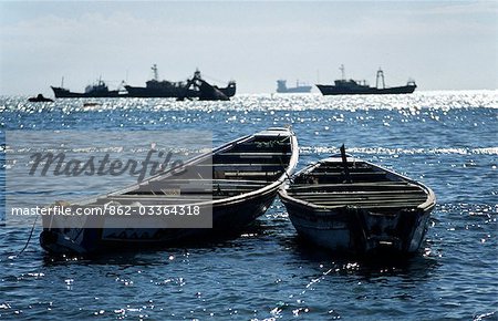 Wooden fishing boats off the coast of Nouadhibou in northern Mauritania. The water surrounding Nouadhibou is the world's richest fishing area.