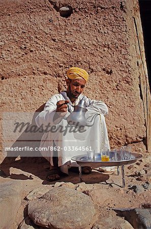 A berber man pours mint tea in an elaborate,timeless ritual.