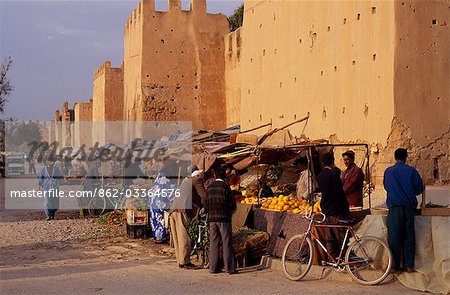 Fruit and vegetable sellers cluster by high,mud-brick walls that completely encircle the town of Taroudannt.