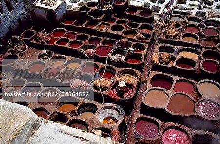 Workers in the dyeing pits of a leather tannery.