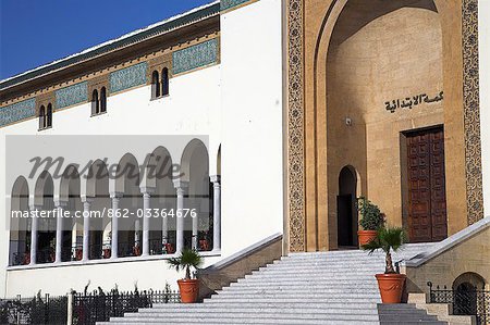 The Palais de Justice (Law Courts) on Place Mohammed V in Casablanca. Designed by Joseph Marrast in 1925 in the Mauresque style,a blend of traditional Moroccan and Art Deco architecture. The huge central arched doorway was modeled on the Persian iwan,a vaulted hall that usually opens onto the central hall of the madersa (theological college) of a mosque.
