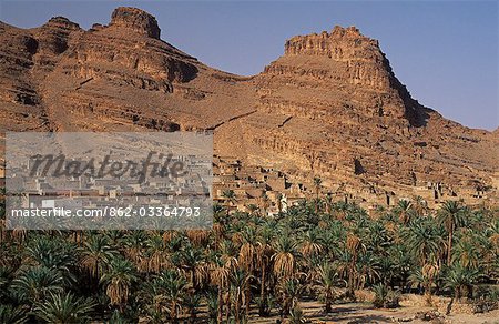 Morocco,Anti-Atlas Mountains,nr. Akka. Nestled at the foot of the Anti-Atlas range,Tadakoust is typical of the region's Berber villages. A lofty crumbling agadir,or fortified granary,tops one of the steep hills.