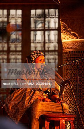 Morocco,Fes. One of the women in The Tartit Women's Ensemble from Mali performs in the Dar Tazi during the Fes Festival of World Sacred Music.