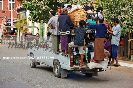 Myanmar. Burma. Nyaung U. An overloaded pick-up vehicle ferries shoppers and farmers to their distant homes from Nyaung U market.