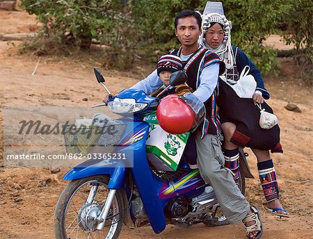 Myanmar,Burma,Namu-op. An Akha family with baggage just manages to ride on one motorcycle near Namu-op village.