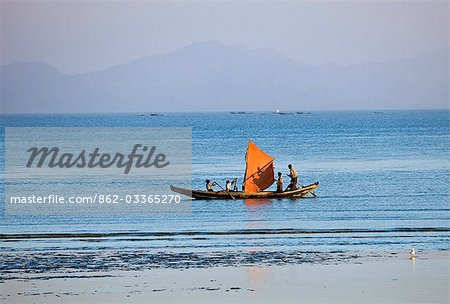 Myanmar, Burma, Rakhaing-Staat. Nach einem atemberaubenden Sonnenuntergang, eilt die Besatzung ein kleines Fischerboot Startseite zum Hafen von Sittwe mit ihren Fang.