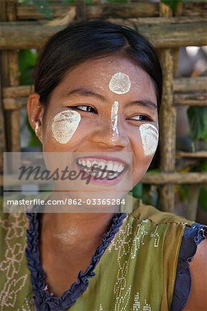 Myanmar,Burma,Kaladan River. A Rakhine woman with Thanakha,a popular local sun cream favoured by women and girls as a skin or anti-wrinkle cream.