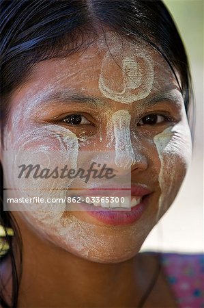 Myanmar,Burma,Mrauk U. A pretty young girl of the Rakhine ethnic group with her face decorated with Thanakha,a popular local sun cream and skin lotion.