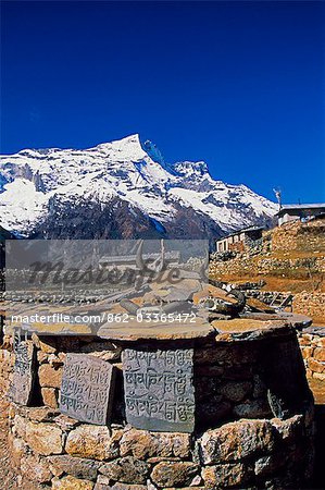 Mani stones,inscribed with Buddhist prayers in Namche Bazaar. Namche Bazaar has long been an important trading post for trans-Himalayan trade with Tibet.