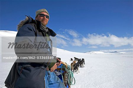 Norway,Troms,Lyngen Alps. Veteran Polar Explorer Norwegian Per Thore Hansen uses his dog sled team to cross the Lyngen Alps inland from Tromso in northern Norway. .