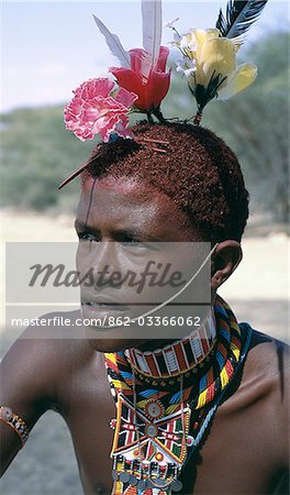 The adornments of Samburu warriors change from generation to generation. In the 1990's cheap plastic flowers from China became fashionable.