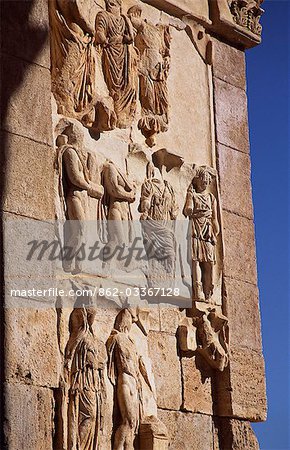 Detail of carved stone figures on the Severan Arch in the ancient Roman city of Leptis Magna. A large triumphal arch standing at the junction of the city's two main roads,the Severan Arch was built from limestone faced with marble. One of the great works of Roman sculpture,the Severan Arch glorifies Emperor Septimus Severus who ruled from AD193-211.