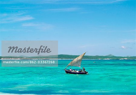 A fishing boat sails off Suarez Island in the crystal-clear waters of Mer d'Emeraude (Emerald Sea). This beautiful sea lies just off the Malagasy coast between Andavakonko and Suarez Island,northeast of Antsiranana (Diego Suarez).