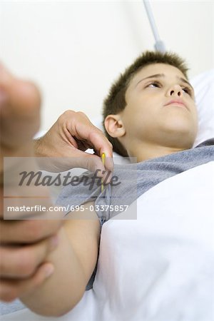 Boy having temperature taken